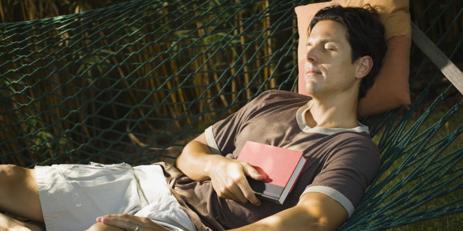 Sleeping man holding book