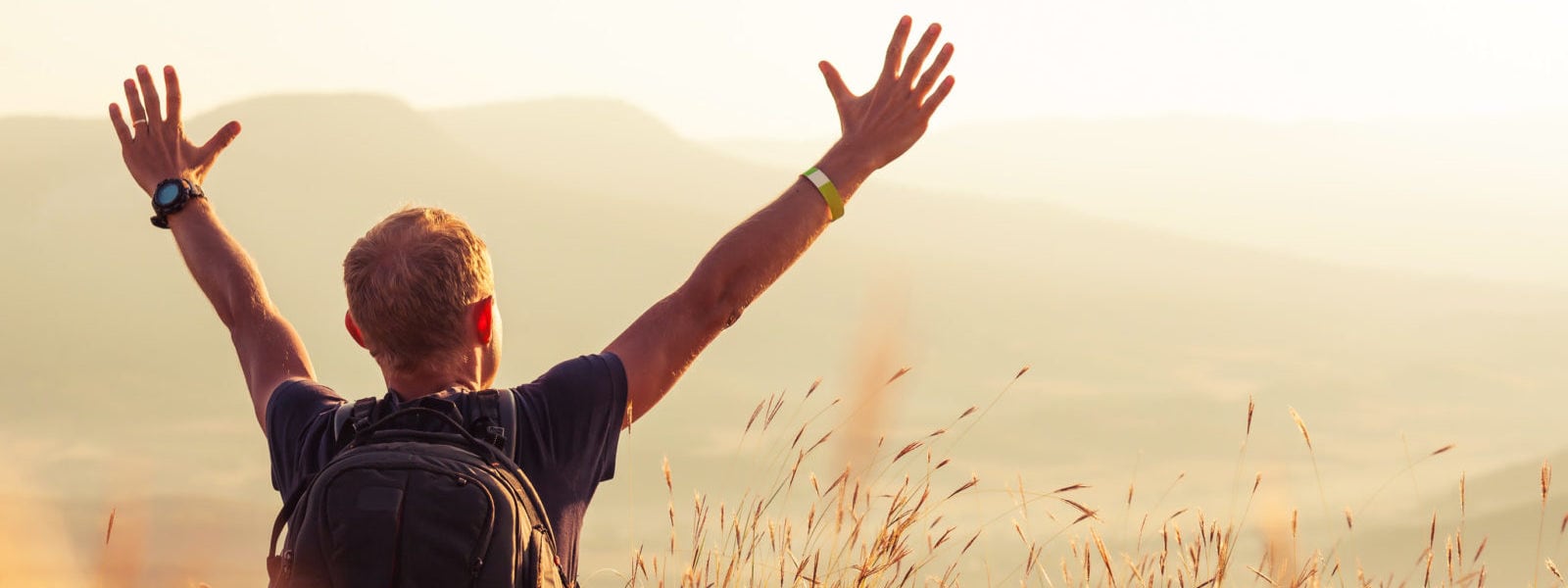 Man greeting golden rising of the sun