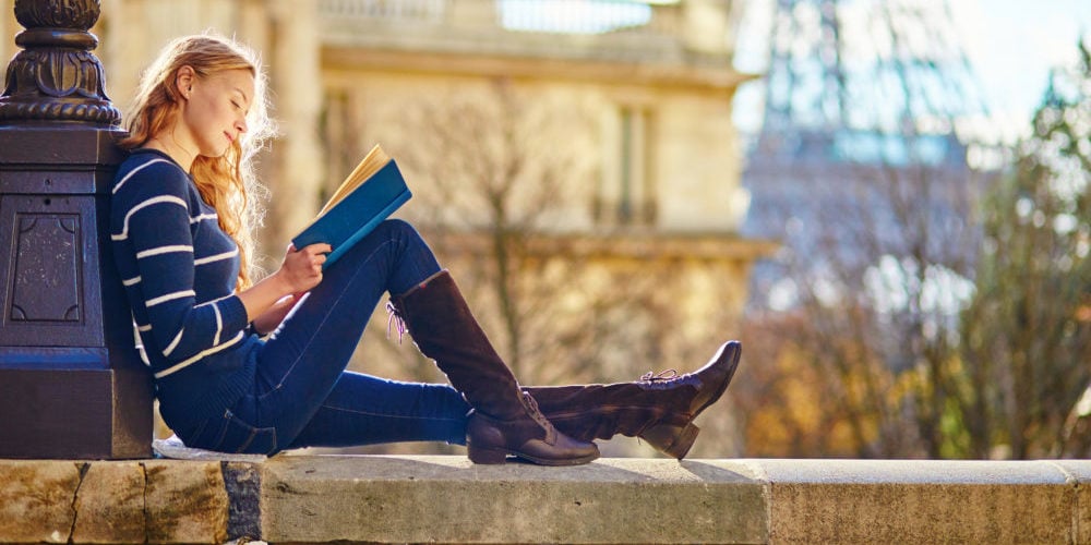 Beautiful woman in Paris, reading a book