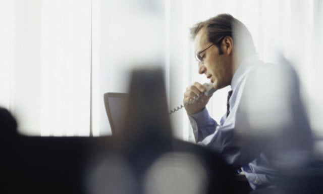 Businessman using phone in office