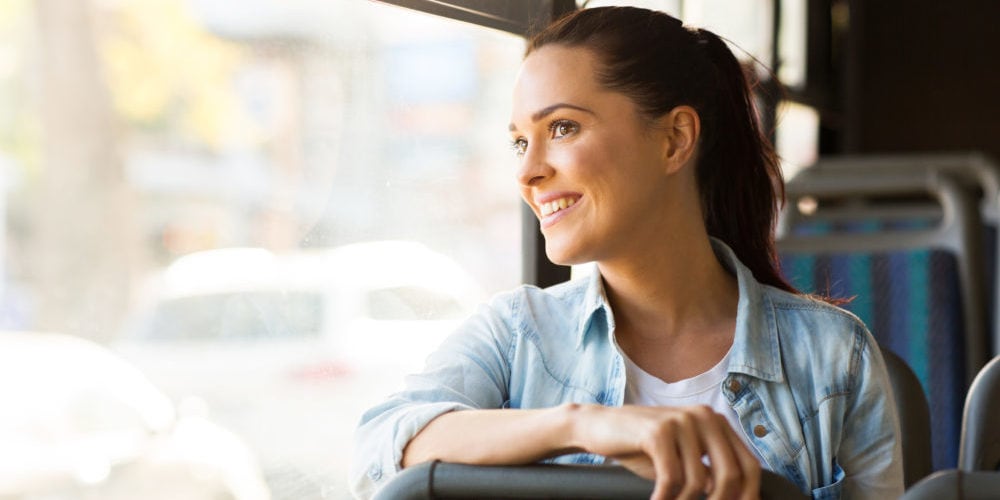 young woman taking bus to work