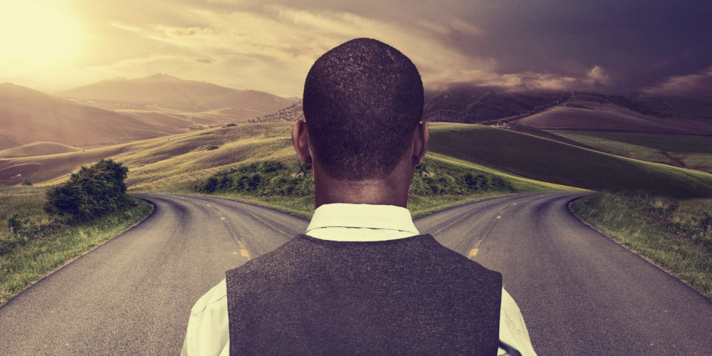 Businessman in front of two roads